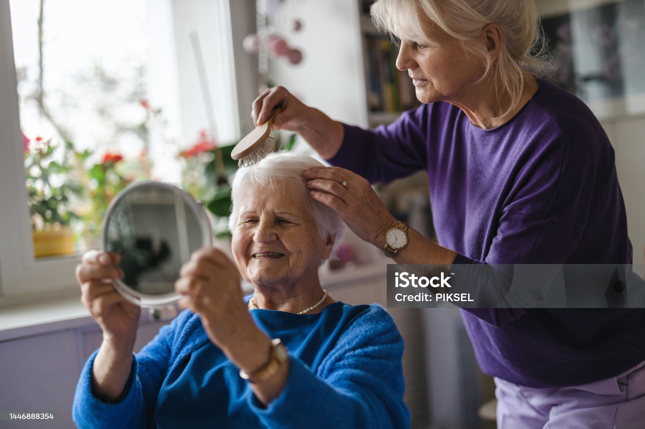 Woman combing hair of elderly mother Pflegedienst Köln Herzblick